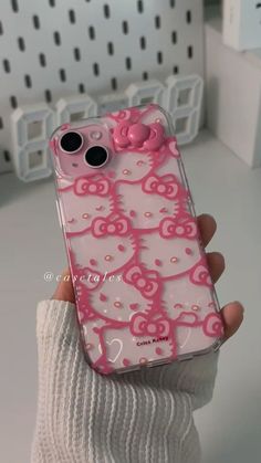 someone is holding up their hello kitty phone case