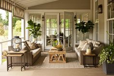 the front porch is decorated with potted plants and other outdoor decorating items,