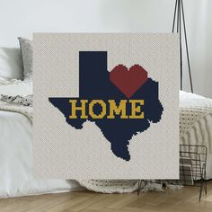 a cross stitch pattern with the word home written across it and a heart in the middle