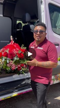 a man standing in front of a van with flowers