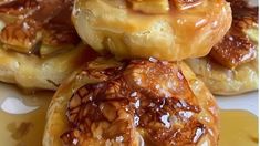 there are many donuts with toppings on top of each other, and one is drizzled with caramel