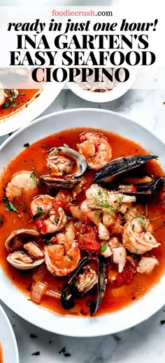 a white bowl filled with seafood and clams