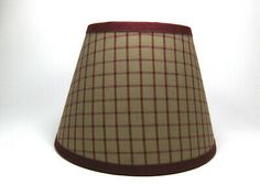 a lamp shade is shown on a white background with a red stripe around the bottom