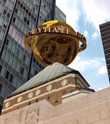 a large golden globe on top of a building