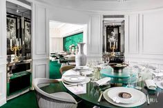 an elegant dining room with white walls and green carpeted flooring is seen in this image