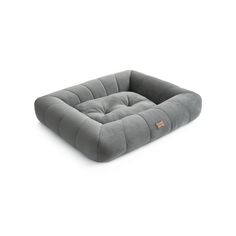 the dog bed is made from grey fabric and has a square shaped cushion on top