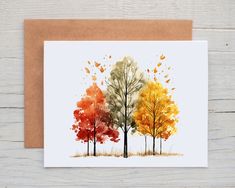 a card with three trees in different colors on the front and back, one is red, one is yellow