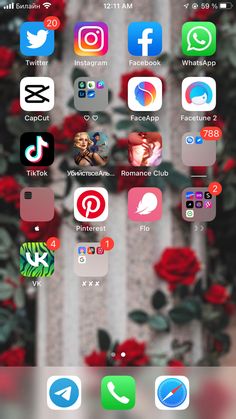 the home screen of an iphone with various icons on it and flowers in the background