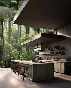 an outdoor kitchen with lots of counter space and plants growing on the wall above it