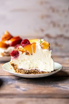 a piece of cheesecake with fruit on top is sitting on a small white plate