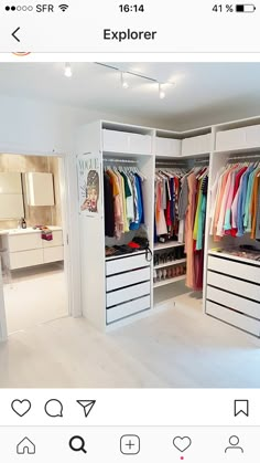 an open closet with clothes hanging on the doors and drawers in front of white walls