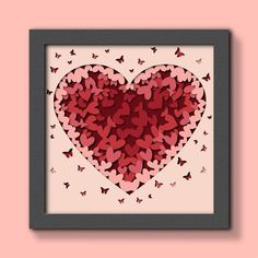 a heart made out of butterflies in a frame on a pink wall with the words love written