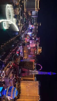 an aerial view of the las vegas strip at night with lights and buildings lit up