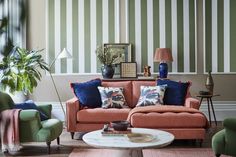 a living room filled with furniture and striped walls