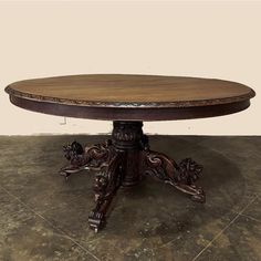 an ornately carved wooden table on top of a tile floor