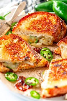 a white plate topped with grilled cheese and green peppers