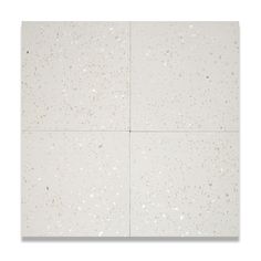 four square white tiles with speckles on them