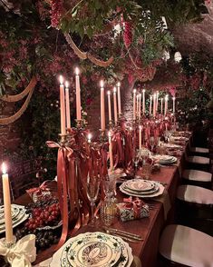 a long table with candles and plates on it