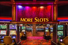 the slot machines are lined up in front of the sign that says more slots on it