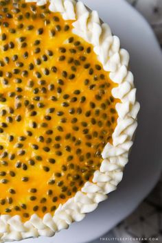 a close up of a pie on a plate with cheese and black olives in it