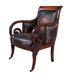 an old fashioned chair with leather upholstered on the back and armrests