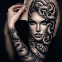 a woman with tattoos on her arm and shoulder is holding a snake in her hand