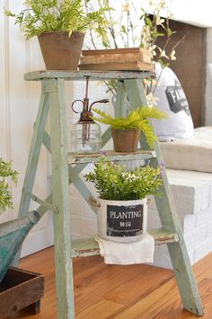 an old ladder is used as a plant stand