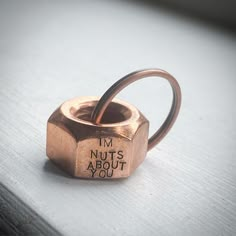 a ring that says i'm nuts about you on the inside of it, sitting on top of a table