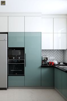 a kitchen with green cabinets and white walls