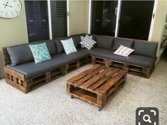 a couch made out of wooden pallets sitting on top of a floor