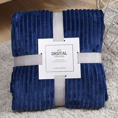 the blue blanket is wrapped in white ribbon