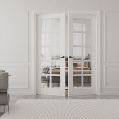 a living room with white walls and doors leading to a bed in the corner on top of a rug