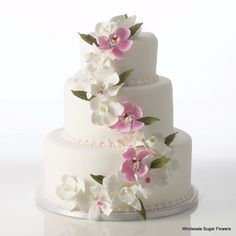 three tiered wedding cake with white and pink flowers