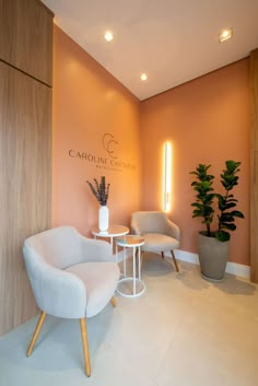 two chairs and a table in front of a wall with the name carolina on it