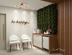 two white chairs sitting in front of a wall with the words be happy on it