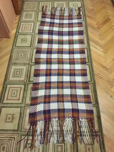 a plaid rug is laying on the floor