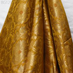 Peanut Butter Indian Wedding Dress Material Fabric By The Yard Silk Banarasi Brocade Home Decor Table Runner Cushion Covers Crafting Sewing. This is a beautiful benarse silk brocade floral design fabric in Brown and Gold. The fabric illustrate golden woven beautiful design on Peanut Butter Brown and Gold Fabric. ➤Listing for 1 Yard of fabric.  ➤Width of the fabric is 44 inches. ➤Code:-bg1292 ➤Color: Peanut Butter Brown and Gold Fabric Type: Blended Silk (Viscose and Silk) Super Fine Quality Brocade Weaving from Banaras, which is known as "Kimkhab". During the Mughal period (1556-1707), when kimkhwāb was extremely popular with the rich, the great centres of brocade weaving were Benares (Vārānasi). You can use this fabric to make Dresses, Tops, Blouses, Jackets, Crafting, Clutches or Evening Luxury Bollywood Gold Embroidered Fabric, Luxury Gold Banarasi Silk Dupatta, Wedding Dress Material, Party Wear Indian Dresses, Silk Brocade, Varanasi, Gold Fabric, Indian Wedding Dress, Brocade Fabric