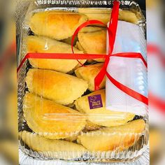 some food wrapped in plastic and tied with a red ribbon