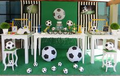 a table with chairs and soccer balls on it