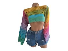 a female mannequin wearing shorts and a colorful sweater on top of her head