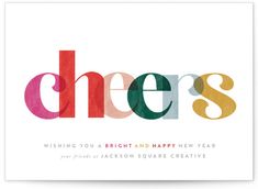 the word cheers written in multicolored letters on a white card with an envelope