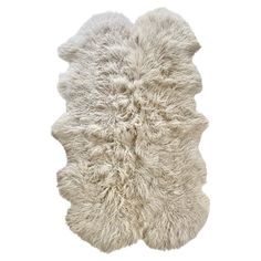 a white sheepskin rug is shown on a white background with no one in it