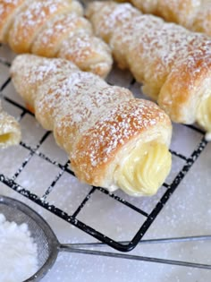 pastries on a cooling rack with powdered sugar