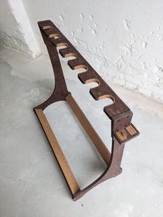 a wooden bench sitting on top of a cement floor