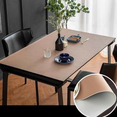 a dining table with two chairs and a vase on it