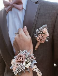 a man in a tuxedo with two boutonnieres on his lapel