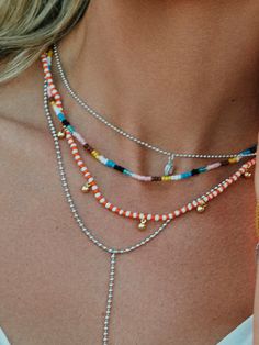 Take a piece of the sunset with you every time you wear this colorful beaded necklace. Crafted with orange and white beads, plus gold dangles, the Sunset Beaded Necklace will effortlessly layer into your beaded or gold summer necklace stacks. Want more beaded necklaces? Shop all of our beaded jewelry. Cheap Orange Beaded Jewelry, Pink And Orange Beaded Necklace, Cheap Playful Beaded Necklaces With Round Beads, Affordable Orange Letter Beads Necklace, Fish Beaded Necklace, Beaded Layered Necklace, Star Beaded Necklace, Beeded Necklace, Necklace Stacks