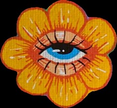 an orange flower with blue eyes on it's center is featured in this image