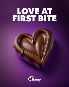 a chocolate heart with the words love at first bite