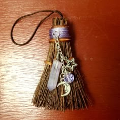 a broom with some charms attached to it